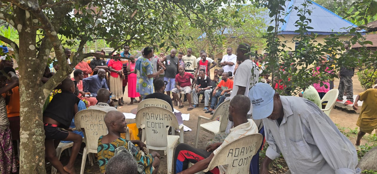 Community consultation held under trees with Adavwan community members